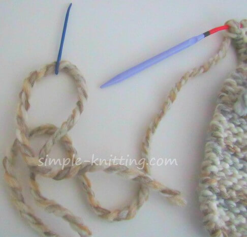 Threading tapestry needle to sew up your knitted slippers Knit Slippers